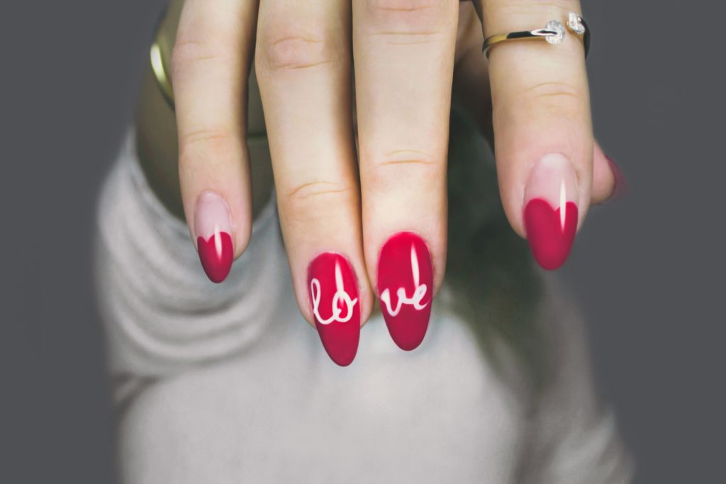 a woman with red nails